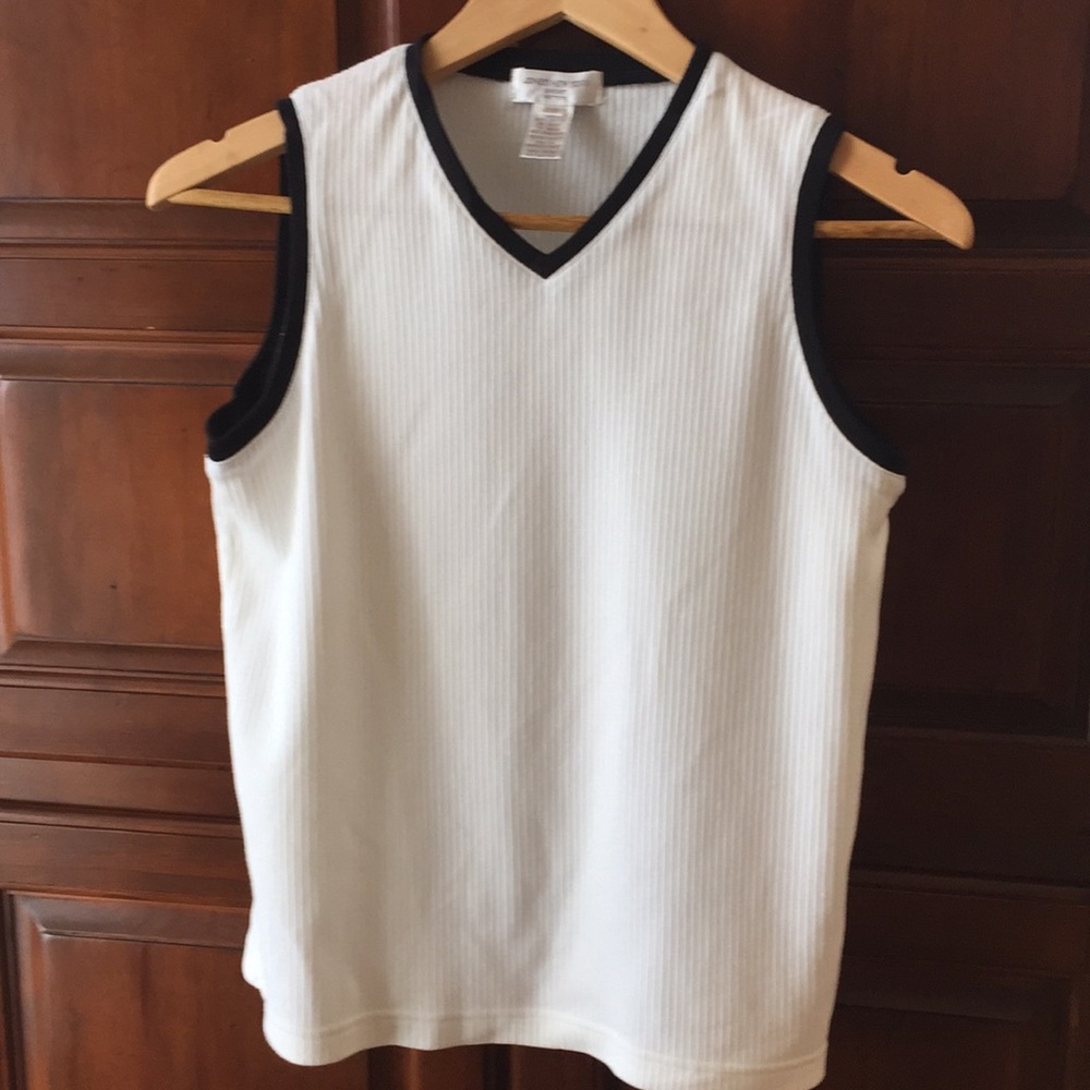 Women’s petite white top with black trim.